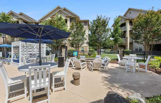 A sunny day at a residential outdoor area with a table and chairs set up.