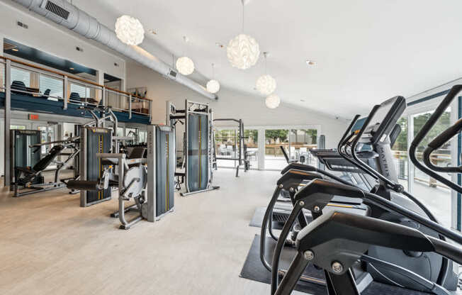 A gym with treadmills, elliptical machines, and other cardio equipment.