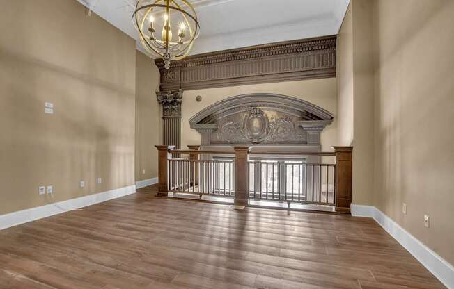 a large living room with a fireplace and a wooden floor at The Knights @ 506 Delaware Apartments, Buffalo, 14202