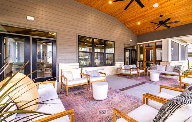 Covered patio with furniture and a ceiling fan at The Parker Austin, Pflugerville, Texas