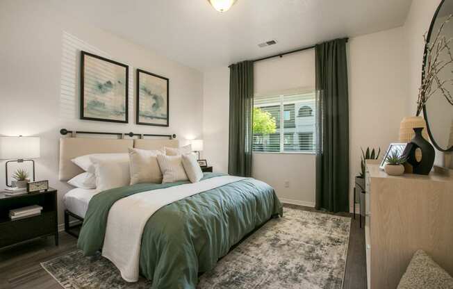 a bedroom with a green and white bed and a window