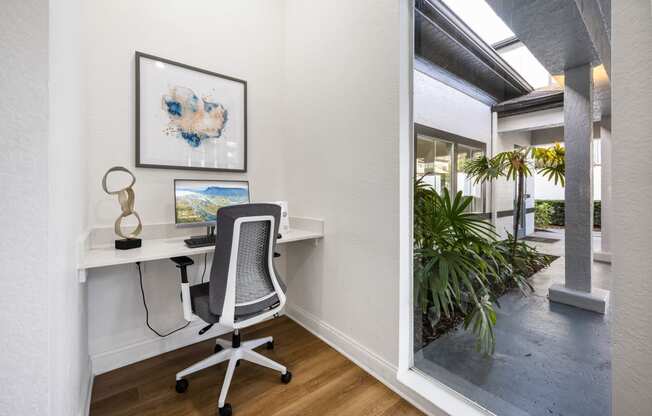 a home office with a desk and a window