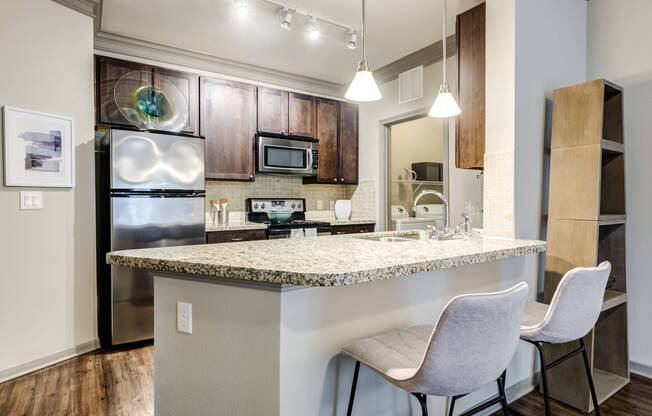 Gourmet kitchen with granite countertops & executive chef undermount sink at Avenues at Craig Ranch apartments for rent