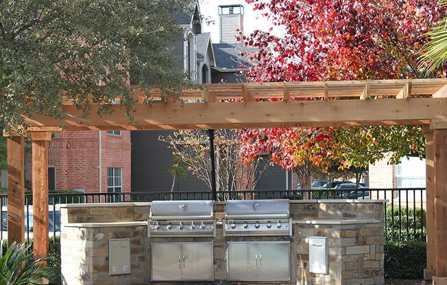 stainless steel barbecues under a pergola