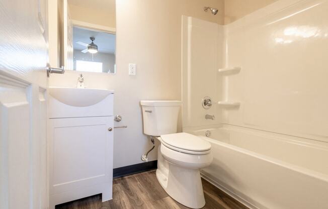 a bathroom with a toilet sink and bath tub