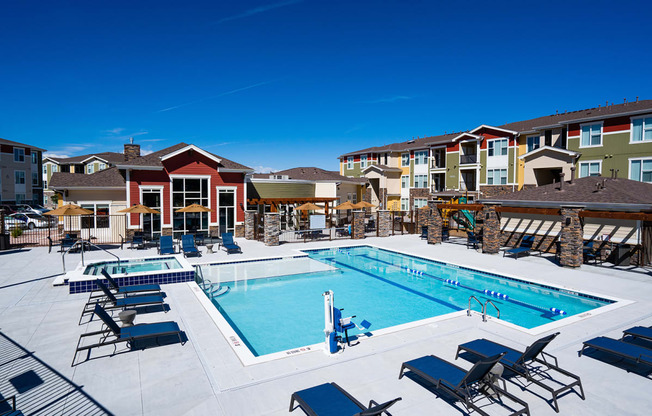 our apartments have a large swimming pool with chairs and tables