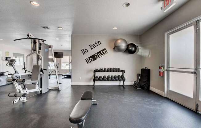 A gym with a sign that says "No Pain No Gain".