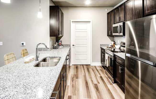 a kitchen with stainless steel appliances and granite counter tops