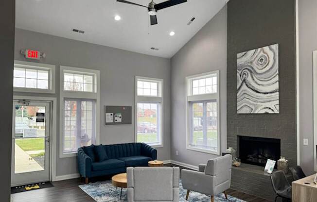 a living room with couches and chairs and a fireplace