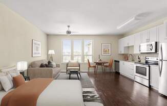 A well-lit, modern kitchen and living room with a large bed in the foreground.