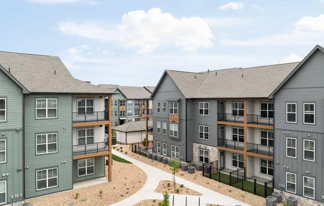 an exterior view of an apartment building with a pathway