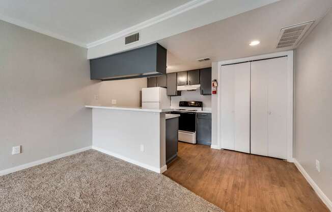 A kitchen area with a white countertop and a black hood.