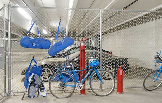 A pair of blue bicycles are parked in a garage.