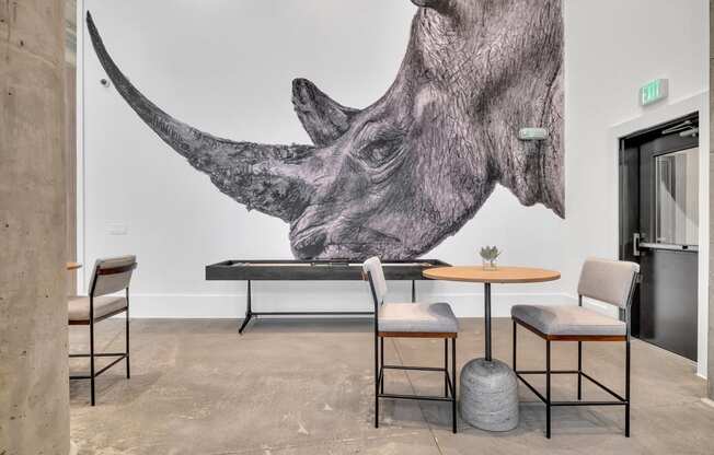 a restaurant with a mural of a rhino on the wall