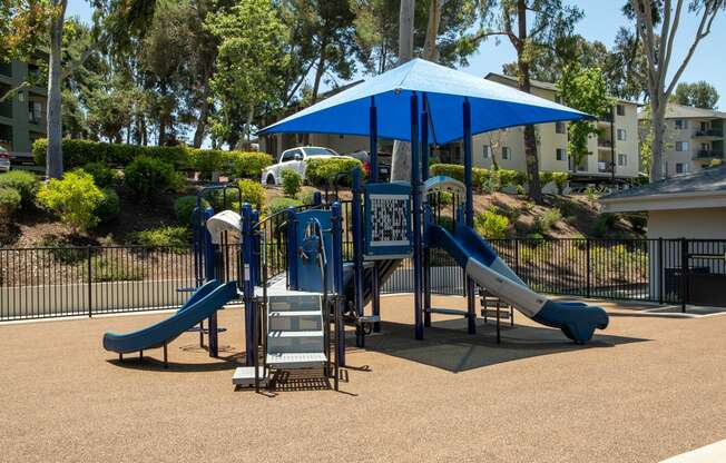 a playground with slides and a tent