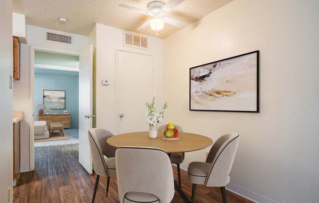 A dining room with a table and chairs.