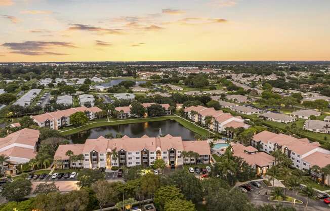 an aerial view of a community with a lake and buildings