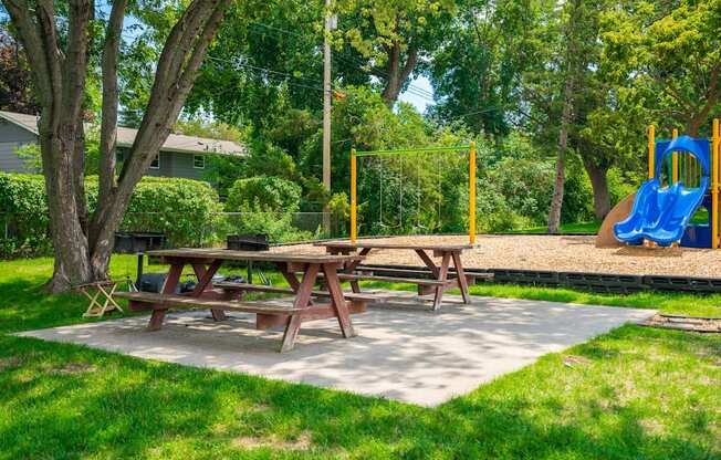 a picnic table and a playground in a park