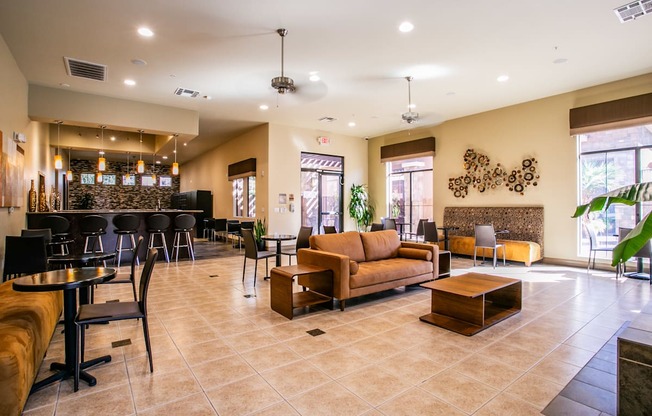 a lobby with couches tables and chairs and a bar