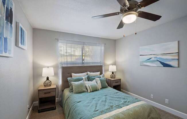 a bedroom with a large bed and a ceiling fan