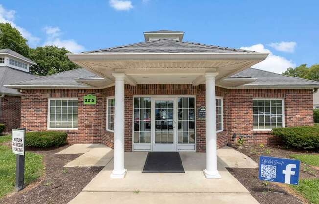 the front entrance of a brick building with a facebook sign