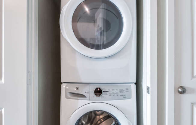 A white washing machine and dryer in a small laundry room.