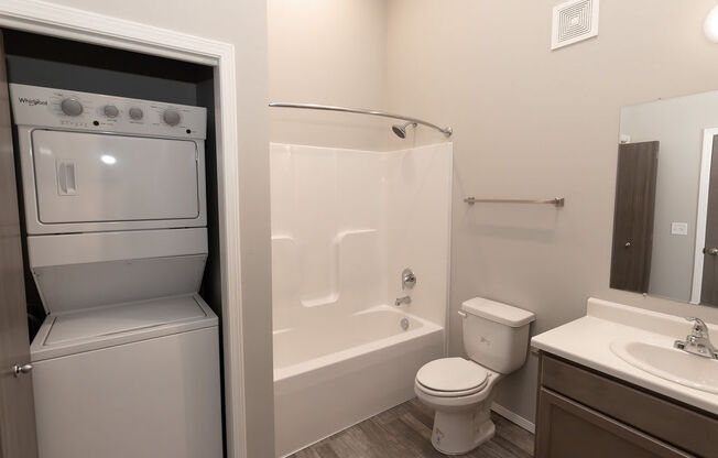 a bathroom with a tub and a sink and a toilet