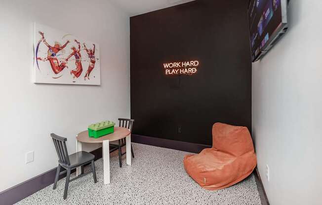 community room with small table, television, and lounge chair