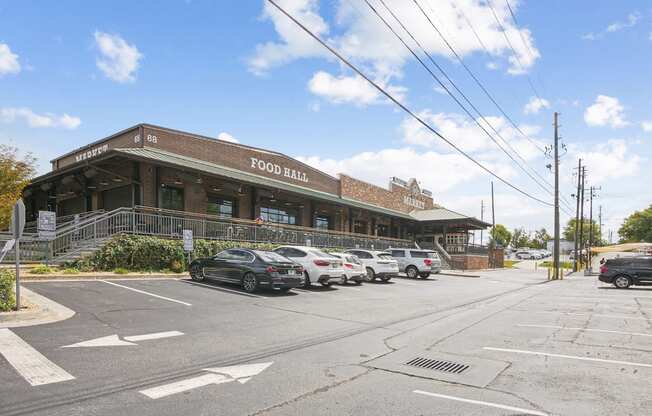 A food hall with cars parked in front.