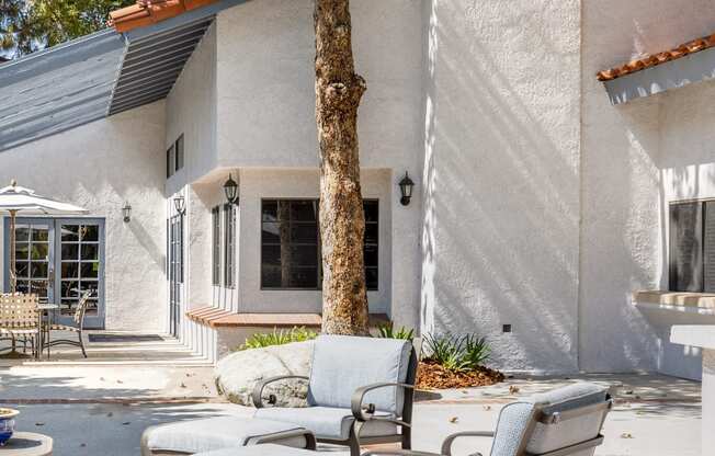 a patio with two chairs and a table