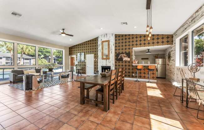 a living room and dining room with a table and chairs