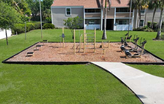 a playground with a statue in the middle of a yard