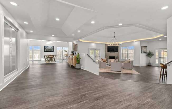 A spacious living room with a staircase leading to the upper level.