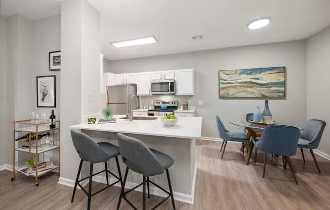 an open kitchen and dining area with a table and chairs