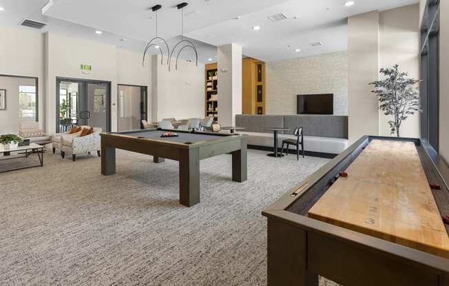 two billiards tables in the clubhouse of a community center with a pool table