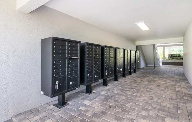 a row of metal lockers in a room with a brick floor