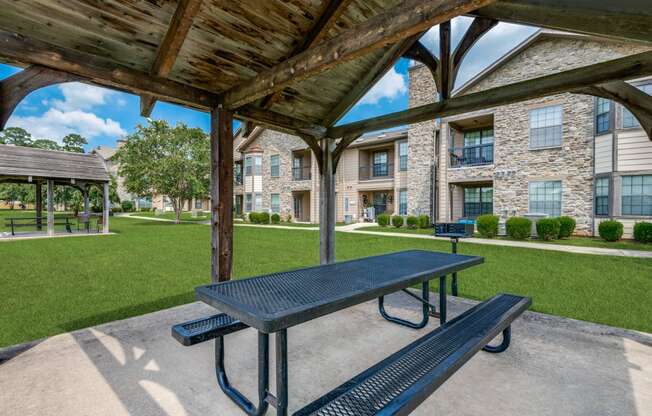 our picnic tables are under a covered pavilion with our apartments in the background