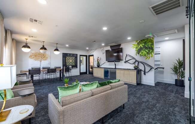 an open concept living room with a kitchen and dining area