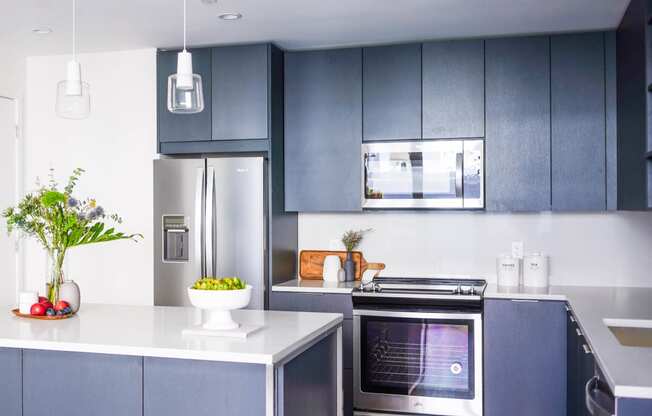 a room with a table and a vase of flowers at The Lively, Jersey City New Jersey