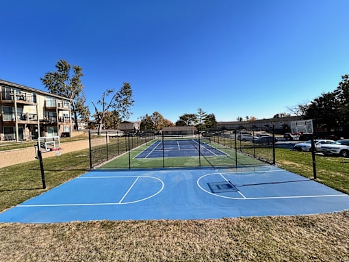 a tennis court with a fence around it on a blue court