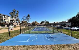 a tennis court with a fence around it on a blue court