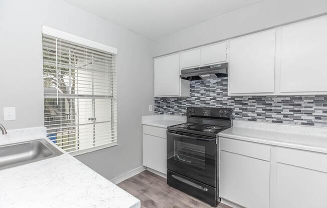 a kitchen with a sink and a window