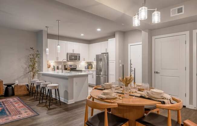 an open kitchen and dining room with a table and chairs