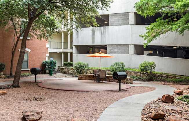 A courtyard with a table and chairs and a mailbox.