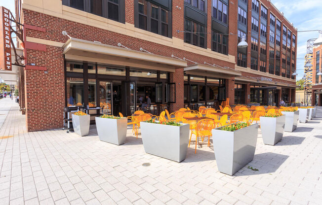the outside of a Brookland Pint with yellow chairs and tables