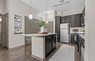 Open Living Room and Kitchen at RiverHouse Apartments in Little Rock, AR