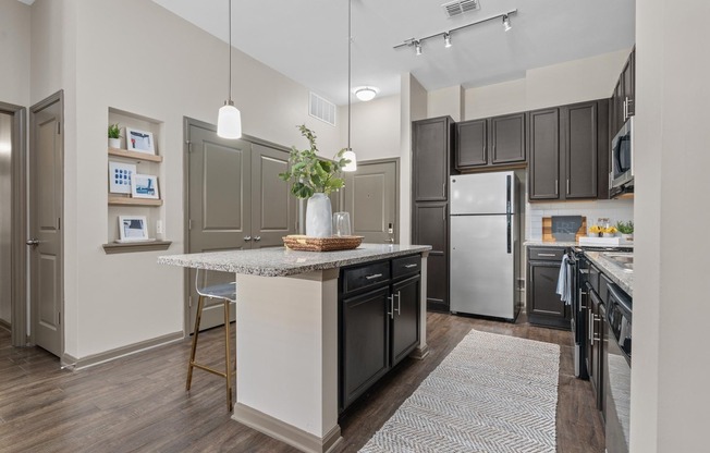 Open Living Room and Kitchen at RiverHouse Apartments in Little Rock, AR
