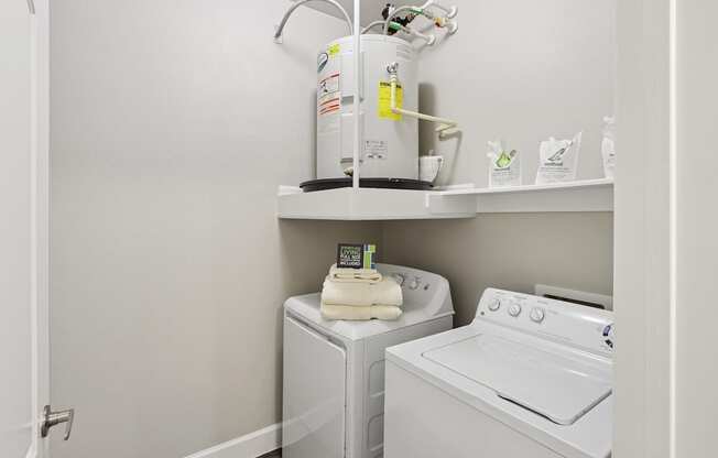 A white washing machine and dryer in a small laundry room.