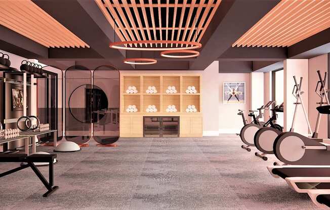 A modern gym with a variety of equipment including treadmills, stationary bikes, and weight machines.