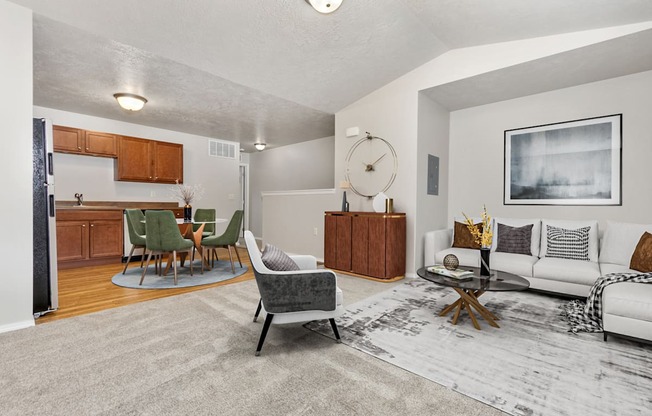 A living room with a grey rug and a white couch.